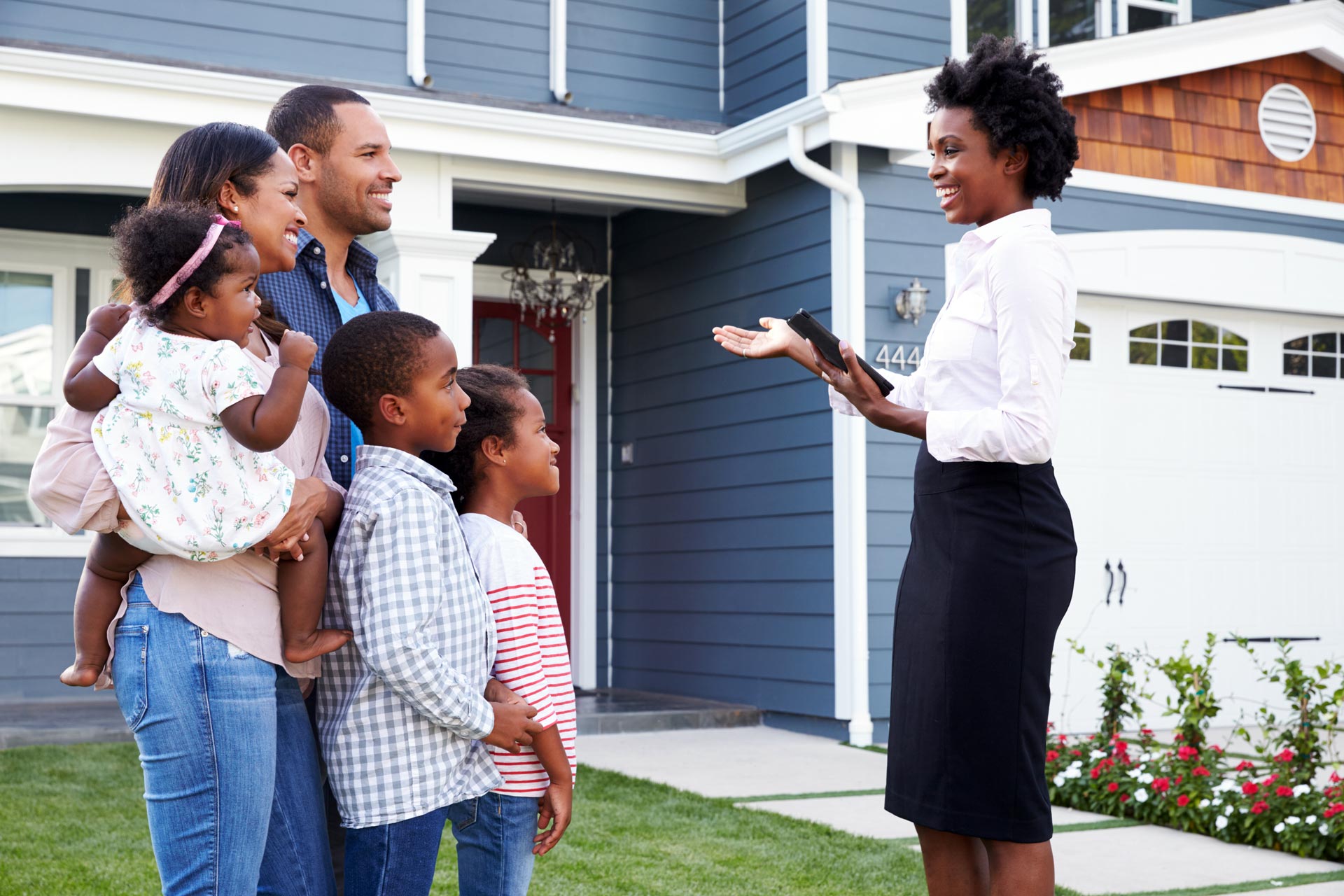 Real estate agent showing a family a house